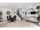 Open floor plan with tile flooring, a staircase, neutral colors, and decorative touches create a modern living space at 10604 Sariah Skye Ave, Las Vegas, NV 89166