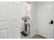 Compact powder room featuring a pedestal sink, decorative mirror, neutral walls, and tile flooring at 10604 Sariah Skye Ave, Las Vegas, NV 89166
