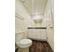 Bright bathroom features a wood floor, white cabinets, and a shower with glass doors at 1163 Meadow Sparrow Pl, Henderson, NV 89011