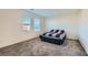 Neutral bedroom features carpet, two windows, and a bed with a striped comforter at 1163 Meadow Sparrow Pl, Henderson, NV 89011