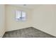 A well-lit bedroom featuring carpet, one window, and neutral walls at 1163 Meadow Sparrow Pl, Henderson, NV 89011