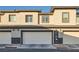 A row of attached homes with garage doors at 1163 Meadow Sparrow Pl, Henderson, NV 89011