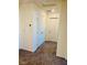 Hallway featuring carpet, white walls, a linen closet, and interior door at 1163 Meadow Sparrow Pl, Henderson, NV 89011
