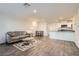 Open-concept living area with hardwood floors flowing into the kitchen and a cozy sofa at 1163 Meadow Sparrow Pl, Henderson, NV 89011