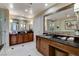 Bathroom featuring double sink vanity, decorative mirrors and glass enclosed shower at 145 E Harmon Ave # 2021, Las Vegas, NV 89109