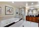 Bathroom with a tub, walk-in shower, double sink vanity with dark counters at 145 E Harmon Ave # 2021, Las Vegas, NV 89109