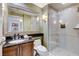 Bathroom with dark vanity, large mirror, toilet and glass enclosed walk-in shower with tile surround at 145 E Harmon Ave # 2021, Las Vegas, NV 89109