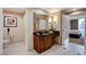 Bathroom featuring vanity with dark countertop and a view of the bedroom at 145 E Harmon Ave # 2021, Las Vegas, NV 89109