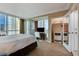 Spacious bedroom boasts a closet, queen-size bed, media center, large windows and neutral decor at 145 E Harmon Ave # 2021, Las Vegas, NV 89109