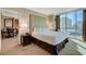 Bedroom featuring a queen-size bed with upholstered headboard and adjacent sitting and dining area at 145 E Harmon Ave # 2021, Las Vegas, NV 89109