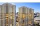 Striking exterior view of golden glass condo towers with beautiful architecture against a bright blue sky at 145 E Harmon Ave # 2021, Las Vegas, NV 89109