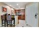 Small kitchen with dark wooden cabinets and bar stools, plus a door at 145 E Harmon Ave # 2021, Las Vegas, NV 89109