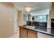 Kitchenette with dark counters, stainless steel appliances, and access to the living room at 145 E Harmon Ave # 2021, Las Vegas, NV 89109