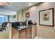 Kitchenette with dark counters, sink, dishwasher, and view to a living space and windows at 145 E Harmon Ave # 2021, Las Vegas, NV 89109