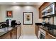Small kitchen with dark cabinets, stainless steel appliances, and granite counters at 145 E Harmon Ave # 2021, Las Vegas, NV 89109