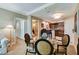 A modern living room with a glass table, bar seating, and a partial view of the bathroom and doorway at 145 E Harmon Ave # 2021, Las Vegas, NV 89109