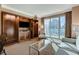Comfortable living room with a built-in entertainment unit and a large window offering expansive city views at 145 E Harmon Ave # 2021, Las Vegas, NV 89109