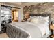 Comfortable bedroom with a mirrored closet door, brick accent wall, and a luxurious bed at 150 Las Vegas Blvd # 2015, Las Vegas, NV 89101