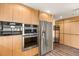 Well-equipped kitchen showcasing stainless steel appliances, wood cabinets, and sleek design for modern living at 150 Las Vegas Blvd # 2015, Las Vegas, NV 89101