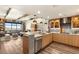 Open-concept kitchen with wood cabinets, stainless steel appliances, and breakfast bar, flowing into a cozy living space at 150 Las Vegas Blvd # 2015, Las Vegas, NV 89101