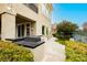 Outdoor kitchen with built-in grill, adjacent to large windows and doors for convenient outdoor entertaining at 1704 Wincanton Dr, Las Vegas, NV 89134