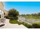 Lush backyard with a fountain, manicured lawn, and elegant seating area overlooking the golf course at 1704 Wincanton Dr, Las Vegas, NV 89134