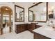 Spacious bathroom featuring double vanities, marble countertops, and archway entrance at 1704 Wincanton Dr, Las Vegas, NV 89134