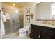 Elegant bathroom featuring a glass-enclosed shower, dark wood vanity, and stylish fixtures at 1704 Wincanton Dr, Las Vegas, NV 89134