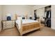 Comfortable bedroom featuring a carved wood bed frame, mirrored closet, and neutral décor at 1704 Wincanton Dr, Las Vegas, NV 89134