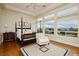 Bright bedroom with large windows and a four-poster bed shows luxury living with golf course views at 1704 Wincanton Dr, Las Vegas, NV 89134
