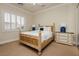 Inviting bedroom with a carved wood bed frame, decorative lamps, and soft, neutral colors at 1704 Wincanton Dr, Las Vegas, NV 89134