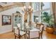 Formal dining room with elegant chandelier, large windows, and classic decor at 1704 Wincanton Dr, Las Vegas, NV 89134