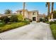 Beautiful Mediterranean-style home with a long driveway and manicured landscaping at 1704 Wincanton Dr, Las Vegas, NV 89134