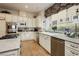Gourmet kitchen with stainless steel appliances, island and granite counters at 1704 Wincanton Dr, Las Vegas, NV 89134