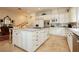 Spacious kitchen with an island, white cabinetry, and stainless steel appliances providing modern convenience at 1704 Wincanton Dr, Las Vegas, NV 89134