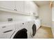 Well-equipped laundry room featuring modern washer and dryer, ample storage, and functional design at 1704 Wincanton Dr, Las Vegas, NV 89134