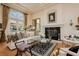 Refined living room featuring ample natural light and a cozy fireplace, perfect for relaxation and socializing at 1704 Wincanton Dr, Las Vegas, NV 89134