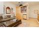 Cozy den featuring built-in bookshelves, a wet bar, comfortable seating, and natural light at 1704 Wincanton Dr, Las Vegas, NV 89134