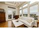 Bright living room with large windows, hardwood floors, and comfortable seating near a balcony at 1704 Wincanton Dr, Las Vegas, NV 89134