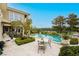 Stunning pool area with lush landscaping and a charming outdoor dining set, perfect for relaxation at 1704 Wincanton Dr, Las Vegas, NV 89134