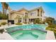A luxury pool with a spa and lush landscaping, showcasing the backyard of the home at 1704 Wincanton Dr, Las Vegas, NV 89134