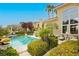 Stunning backyard pool and lush landscaping with mature trees and desert plants create a private oasis at 1704 Wincanton Dr, Las Vegas, NV 89134