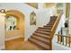 Elegant curved staircase with neutral carpet and wood banister at 1704 Wincanton Dr, Las Vegas, NV 89134