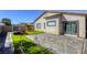Backyard with artificial turf, a playset, paver patio, and easy access to the house at 1809 Lazy Hill Ranch Way, North Las Vegas, NV 89081