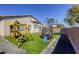 Backyard featuring playset and trampoline, set on artificial turf and rock border at 1809 Lazy Hill Ranch Way, North Las Vegas, NV 89081