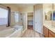 Bathroom featuring a shower, separate tub, and neutral color palette at 1809 Lazy Hill Ranch Way, North Las Vegas, NV 89081