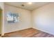 Bedroom with wood flooring, single window, and neutral walls at 1809 Lazy Hill Ranch Way, North Las Vegas, NV 89081