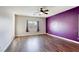 Spacious bedroom with a modern ceiling fan and wood flooring at 1809 Lazy Hill Ranch Way, North Las Vegas, NV 89081