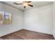 Bedroom features wood-look floors, ceiling fan and a window providing natural light at 1809 Lazy Hill Ranch Way, North Las Vegas, NV 89081