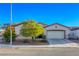 Charming single-story home featuring a two-car garage and well-maintained landscaping in a suburban neighborhood at 1809 Lazy Hill Ranch Way, North Las Vegas, NV 89081